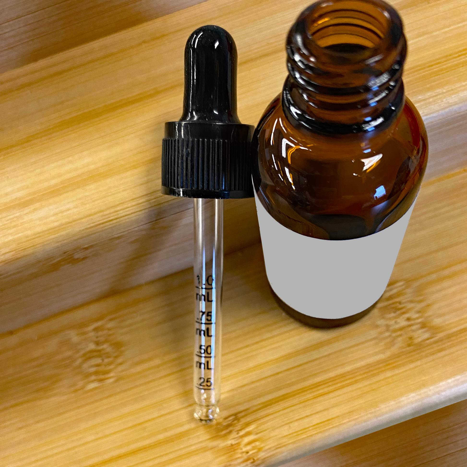 a bottle of brown liquid sitting on top of a wooden table