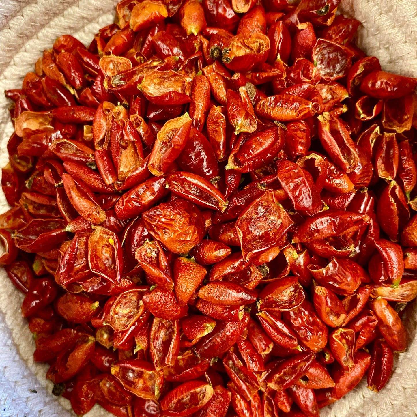 a bowl filled with lots of dried red peppers